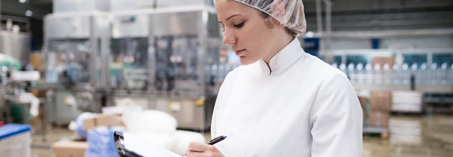 Factory with woman going through a checklist Factory with woman going through a checklist